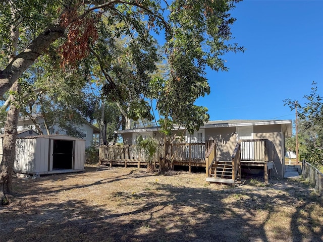 view of yard featuring a deck and a storage unit