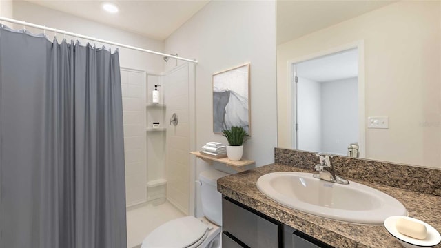 bathroom featuring vanity, toilet, and curtained shower