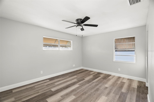 unfurnished room with hardwood / wood-style floors and ceiling fan