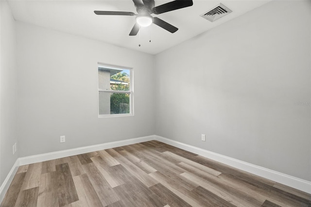 spare room featuring ceiling fan and light hardwood / wood-style flooring