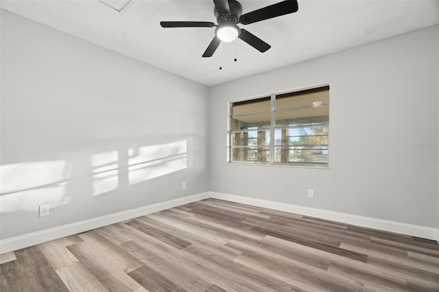 spare room featuring hardwood / wood-style floors, a healthy amount of sunlight, and ceiling fan