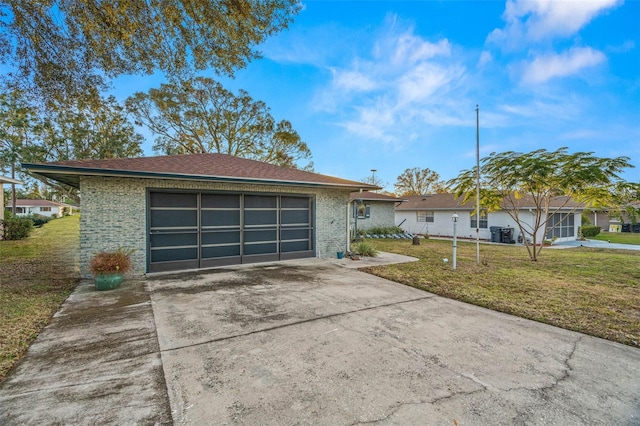 ranch-style house with a garage and a front lawn