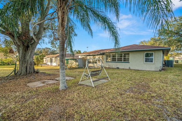 rear view of house with a yard