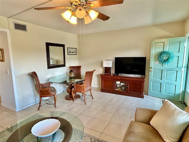 tiled living room with ceiling fan