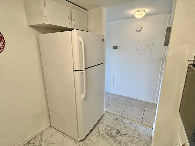 kitchen with white cabinetry and white fridge