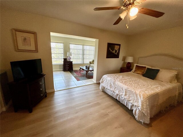 bedroom featuring ceiling fan and light hardwood / wood-style flooring