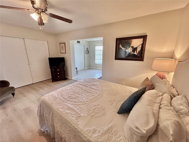 bedroom with ceiling fan and a closet