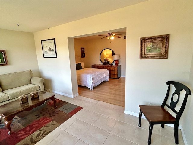 tiled bedroom featuring ceiling fan