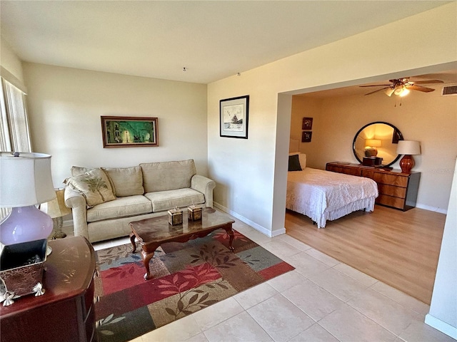 bedroom with ceiling fan and light tile patterned floors