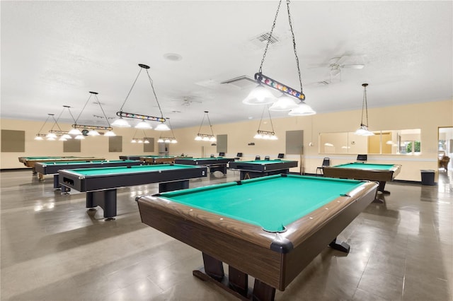 rec room with a textured ceiling, ceiling fan, and billiards