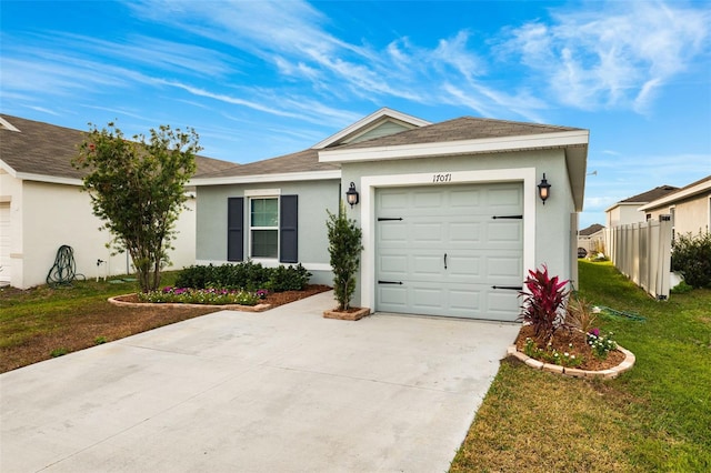 ranch-style house featuring a front yard and a garage