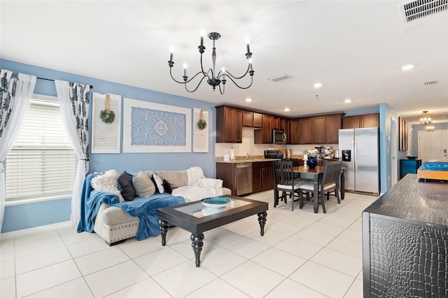 living room featuring light tile patterned flooring and a notable chandelier