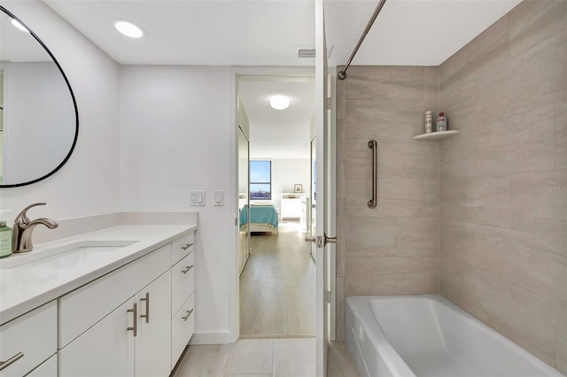 bathroom featuring visible vents, vanity, connected bathroom, and bathing tub / shower combination