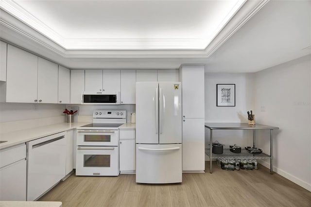 kitchen with white appliances, light wood-style floors, white cabinets, light countertops, and crown molding