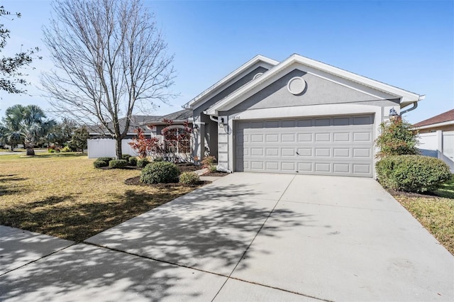 single story home with a garage and a front lawn