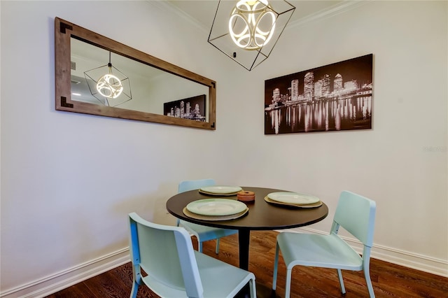 dining space featuring ornamental molding, dark hardwood / wood-style floors, and an inviting chandelier