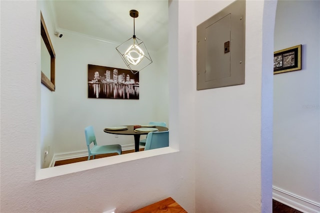 hallway with crown molding and electric panel