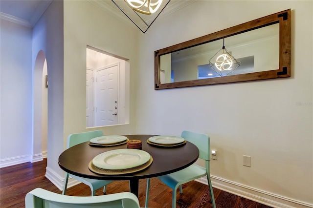 dining space featuring dark hardwood / wood-style flooring and crown molding