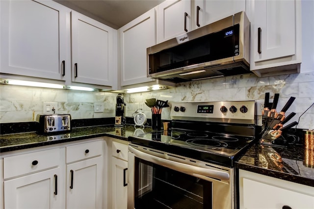 kitchen with backsplash, appliances with stainless steel finishes, and white cabinets