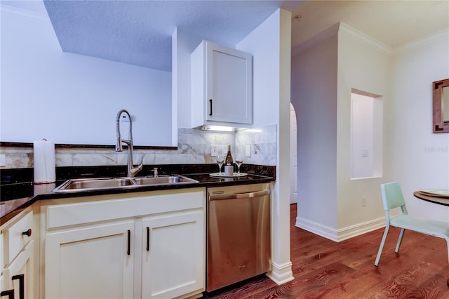 kitchen featuring sink, crown molding, hardwood / wood-style floors, white cabinets, and stainless steel dishwasher