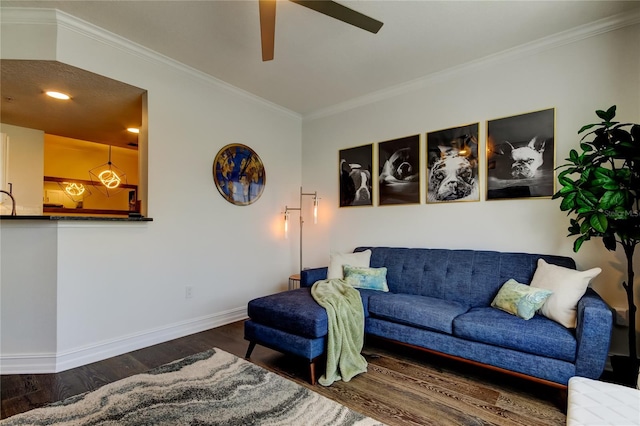 living room with crown molding, dark hardwood / wood-style floors, and ceiling fan