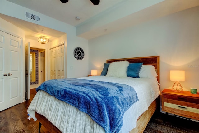 bedroom with dark hardwood / wood-style flooring and ceiling fan