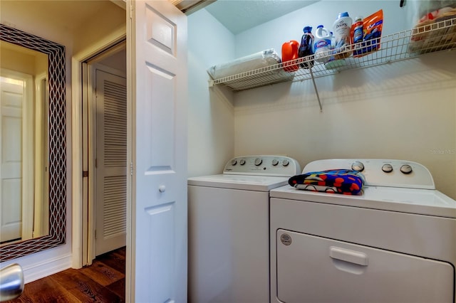 laundry room featuring dark hardwood / wood-style flooring and washer and dryer