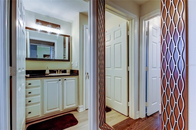 bathroom featuring vanity and hardwood / wood-style flooring