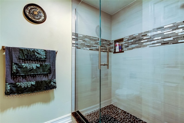 bathroom featuring a shower with shower door