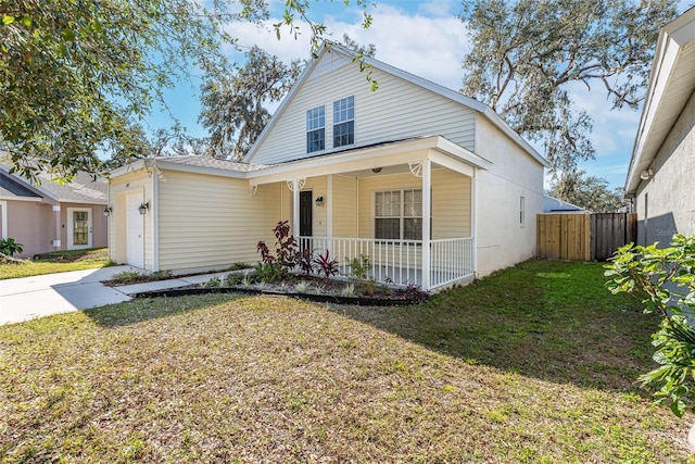 view of front of home featuring a porch, a garage, and a front lawn