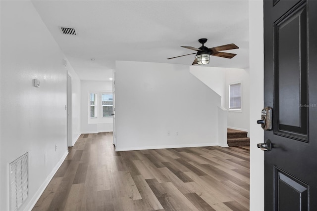 foyer entrance with ceiling fan and light hardwood / wood-style flooring