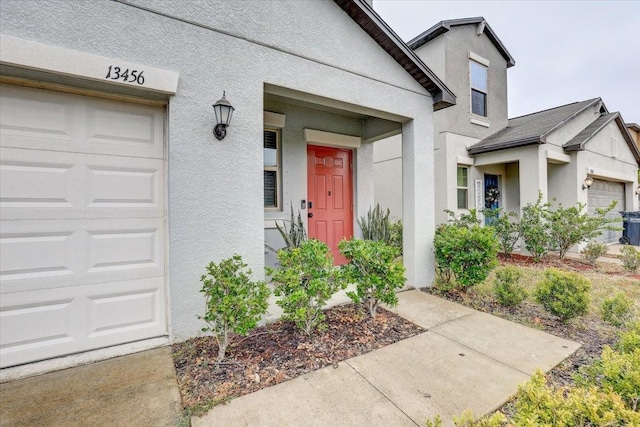 view of exterior entry with a garage