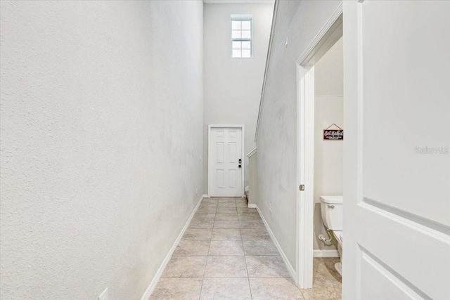 hall with light tile patterned floors