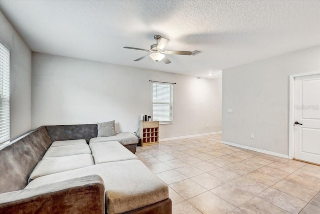 tiled living room featuring a textured ceiling and ceiling fan