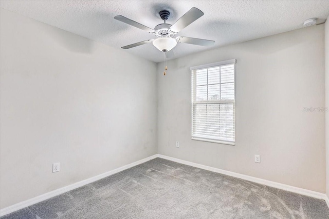 spare room with ceiling fan, carpet, and a textured ceiling