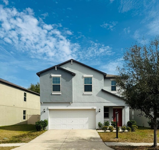 front of property with a garage and a front lawn