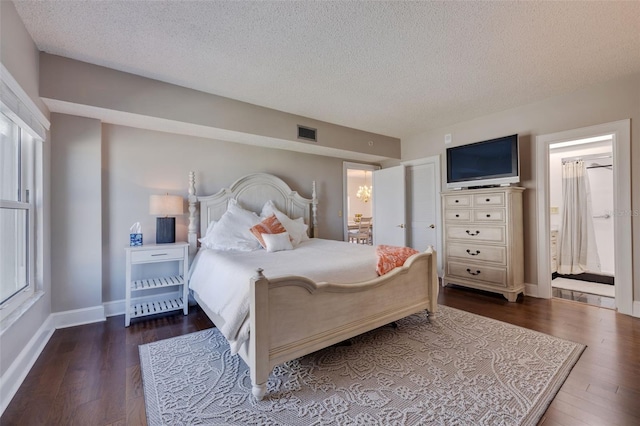 bedroom with a textured ceiling and dark hardwood / wood-style floors