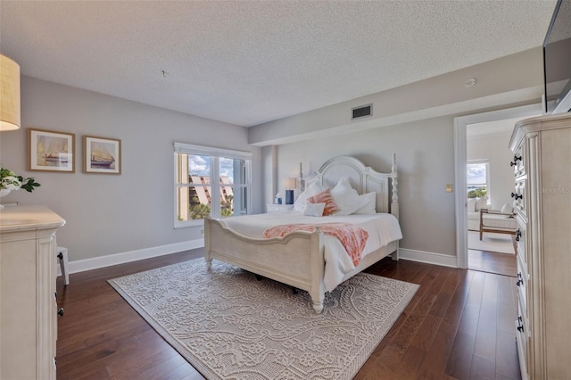 bedroom featuring dark wood-type flooring and a textured ceiling