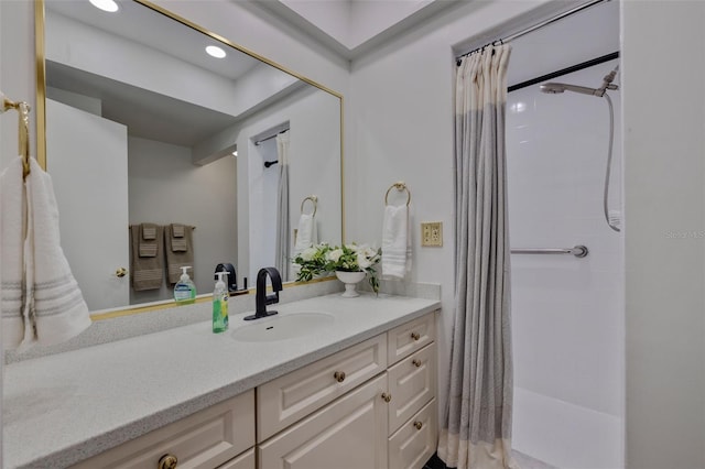 bathroom featuring walk in shower and vanity