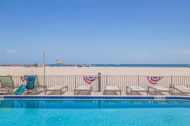 view of swimming pool featuring a water view