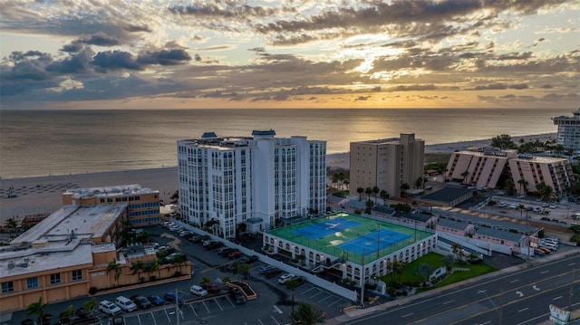 aerial view at dusk featuring a water view