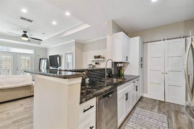 kitchen with kitchen peninsula, white cabinets, and dishwasher