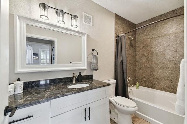 full bathroom featuring hardwood / wood-style flooring, toilet, vanity, and shower / bath combo