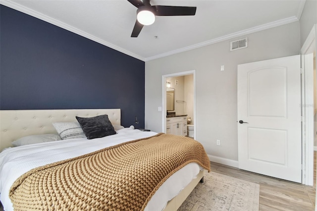 bedroom with light wood-type flooring, ceiling fan, ornamental molding, and ensuite bath