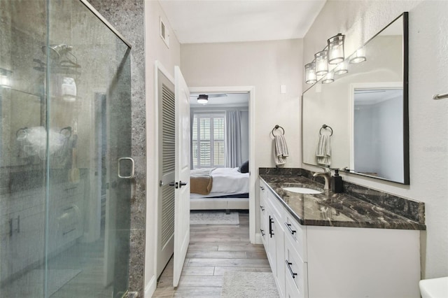 bathroom featuring an enclosed shower and vanity