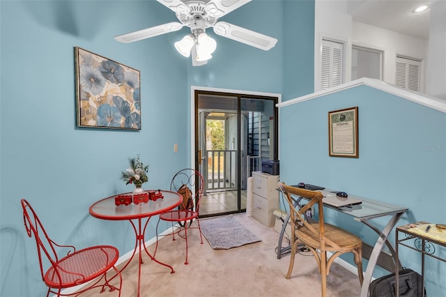 carpeted home office with ceiling fan