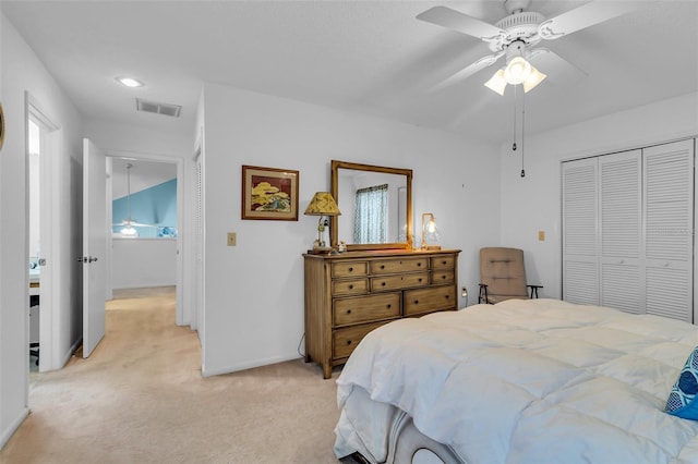 bedroom with a closet, ceiling fan, and light carpet