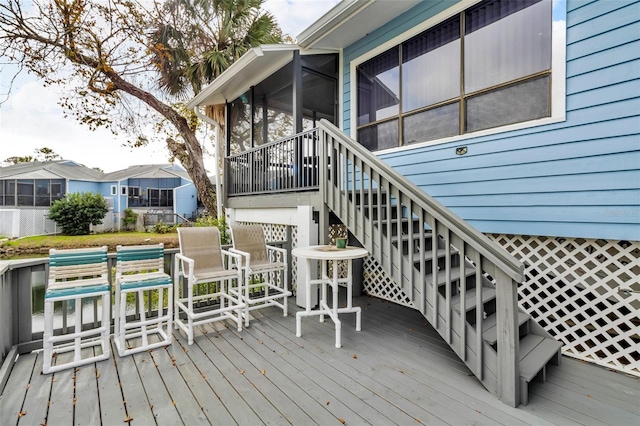 wooden deck featuring a sunroom