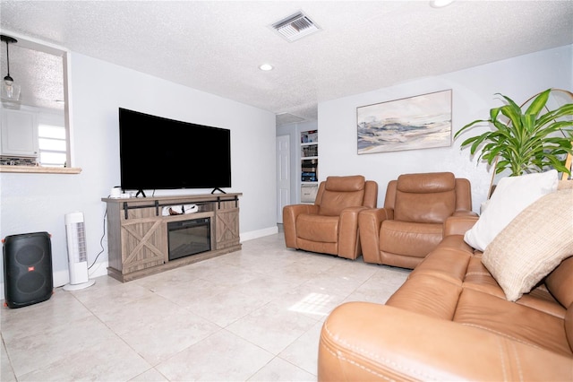 living room featuring light tile patterned flooring and a textured ceiling