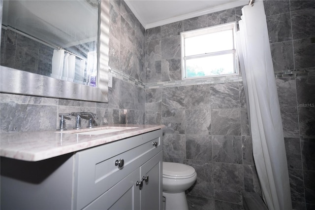 bathroom with toilet, vanity, tile walls, crown molding, and curtained shower